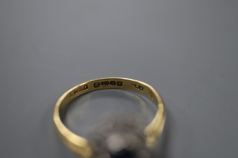 A modern 18ct gold and plat, sapphire and diamond oval cluster ring, size L, gross 2.6 grams.